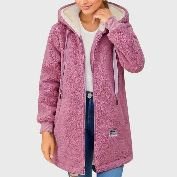 Pink sherpa zip-up hooded coat, cream hood lining, front zipper, patch logo.
