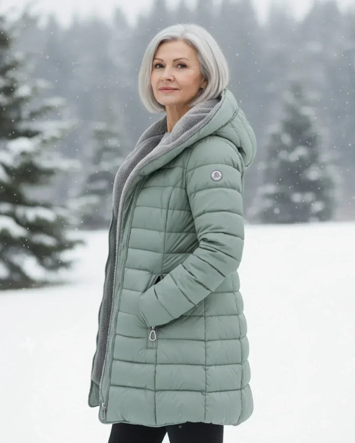 Light green padded winter jacket with gray hood lining, side view, front zipper.