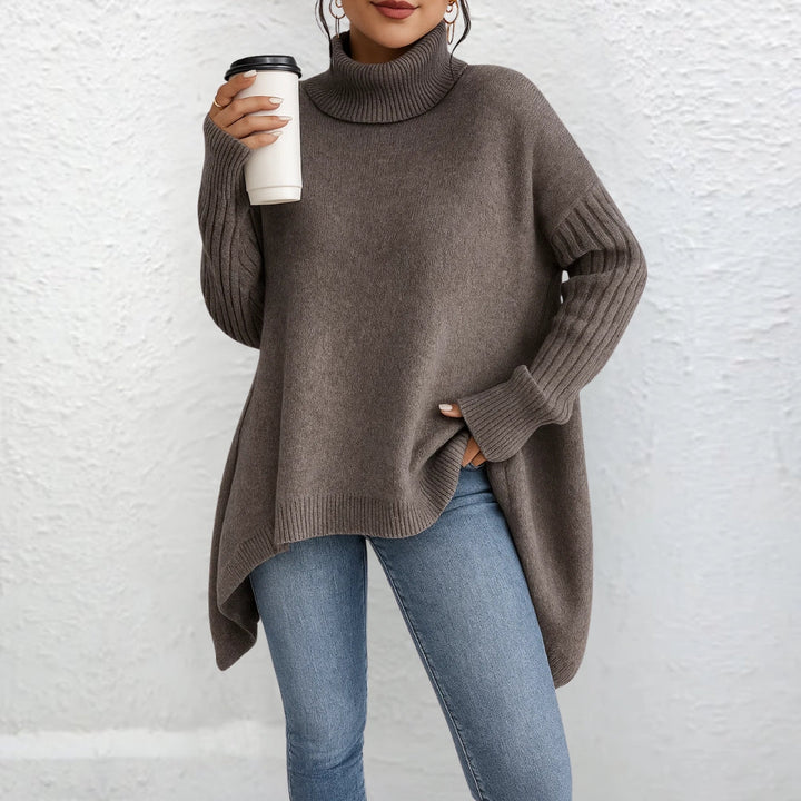 Brown turtleneck sweater with long sleeves and ribbed cuffs, asymmetrical hem.