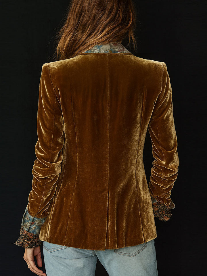 Back view of brown velvet blazer with structured shoulder seams and full sleeves