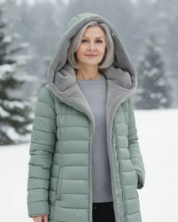 Light green padded winter jacket with gray sherpa hood lining, front zipper, pockets.