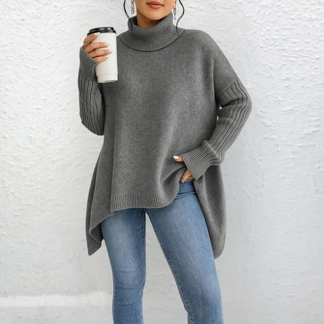 Gray turtleneck sweater with long sleeves and ribbed cuffs, relaxed drape.
