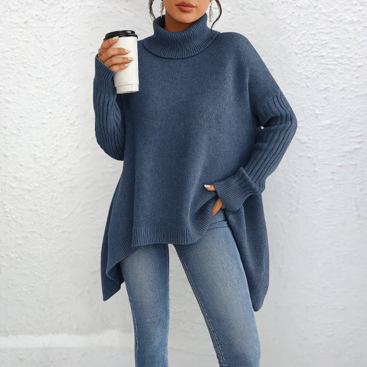 Blue turtleneck sweater with long sleeves and ribbed cuffs, loose fit.
