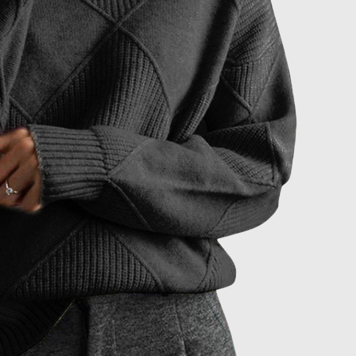 Black turtleneck jumper sleeve close-up with ribbed cuff and knit texture