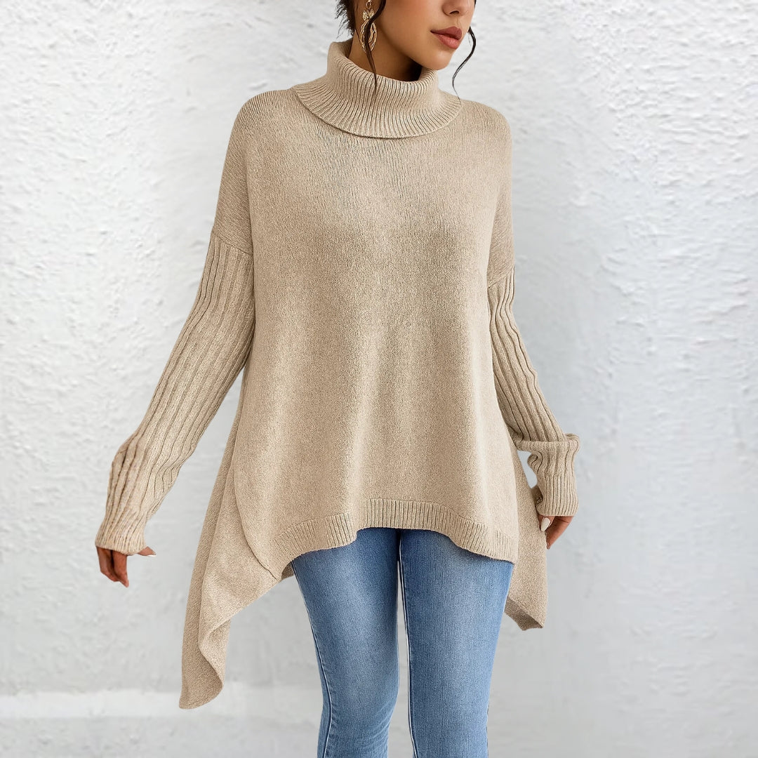 Beige turtleneck sweater with long sleeves and ribbed cuffs, relaxed A-line shape.