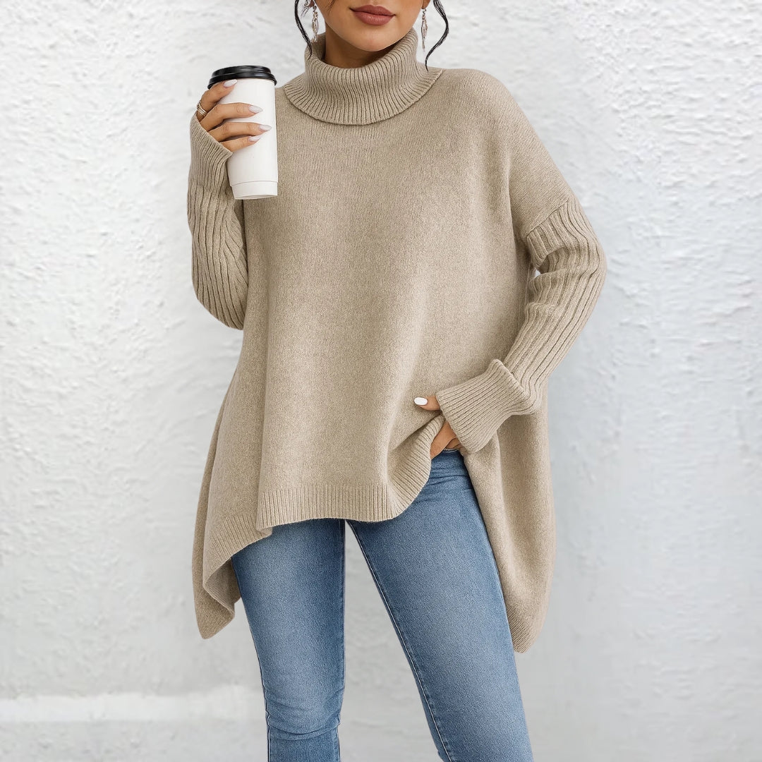 Beige turtleneck sweater with long sleeves and ribbed cuffs, asymmetrical hem.