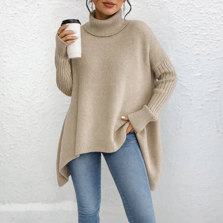 Beige turtleneck sweater with long sleeves and ribbed cuffs, asymmetrical hem.