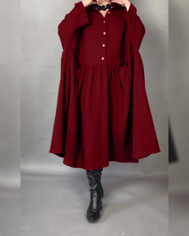 Red button-front A-line dress with point collar and long sleeves, gathered skirt.