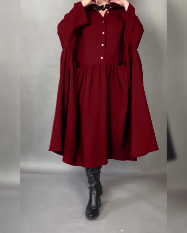Red button-front A-line dress with point collar and long sleeves, gathered skirt.
