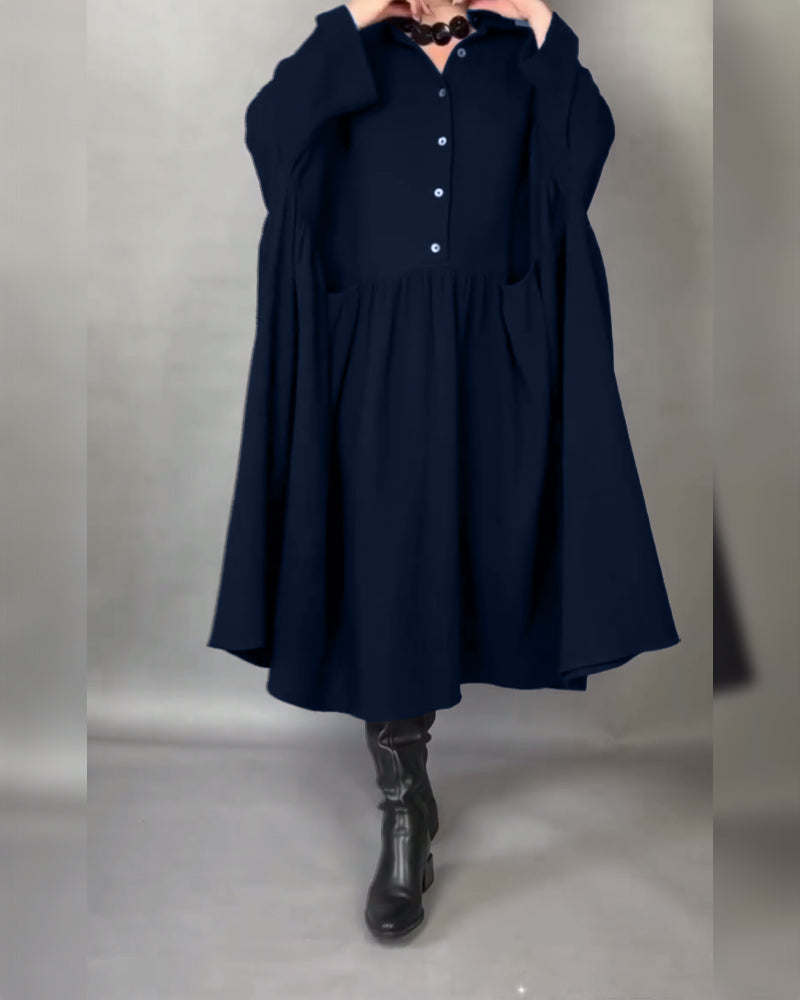 Navy blue button-front A-line dress with point collar and long sleeves, gathered skirt.