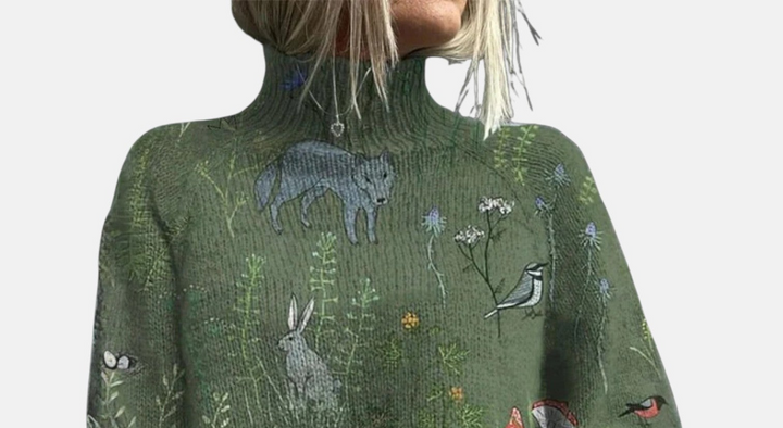 Green turtleneck jumper close-up with embroidered birds, plants, and small details