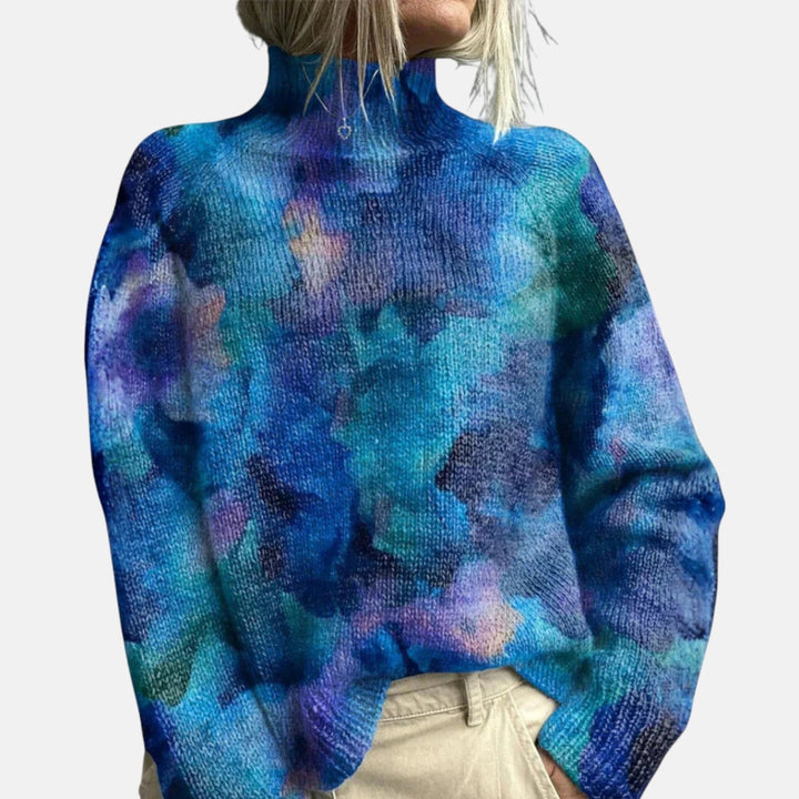 Blue tie-dye turtleneck jumper close-up with multicolor cloud-like pattern