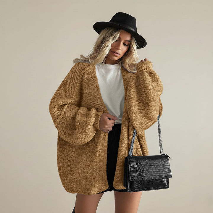 Caramel relaxed knit cardigan with open front and voluminous sleeves, worn with shorts