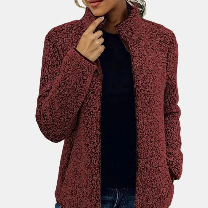Burgundy teddy jacket with full-zip front and side pockets, worn over a top.