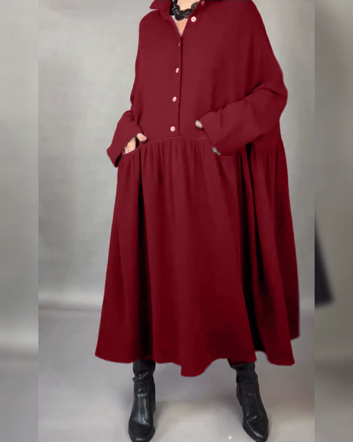 Red A-line button dress with point collar, long sleeves, and gathered waist detail.