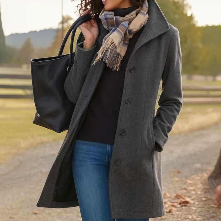 Dark grey long button-front coat with notched lapels and side pockets, worn open
