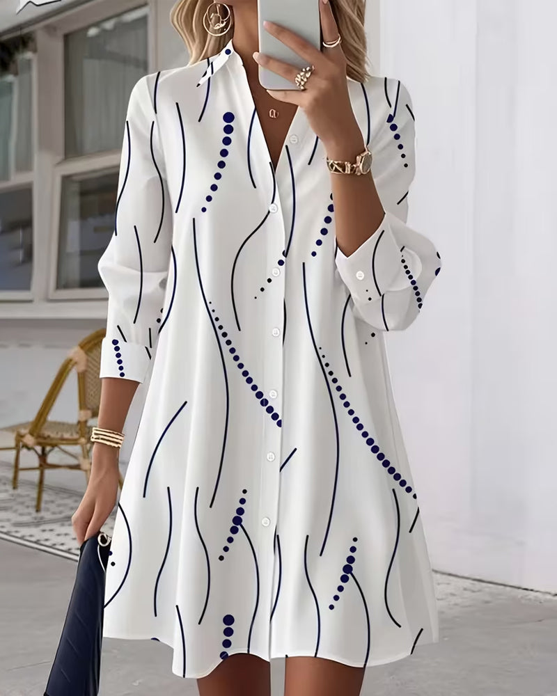 White long-sleeve shirt dress with navy abstract wavy pattern and button placket