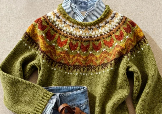Green knit jumper close-up showing patterned yoke and textured stitch detail