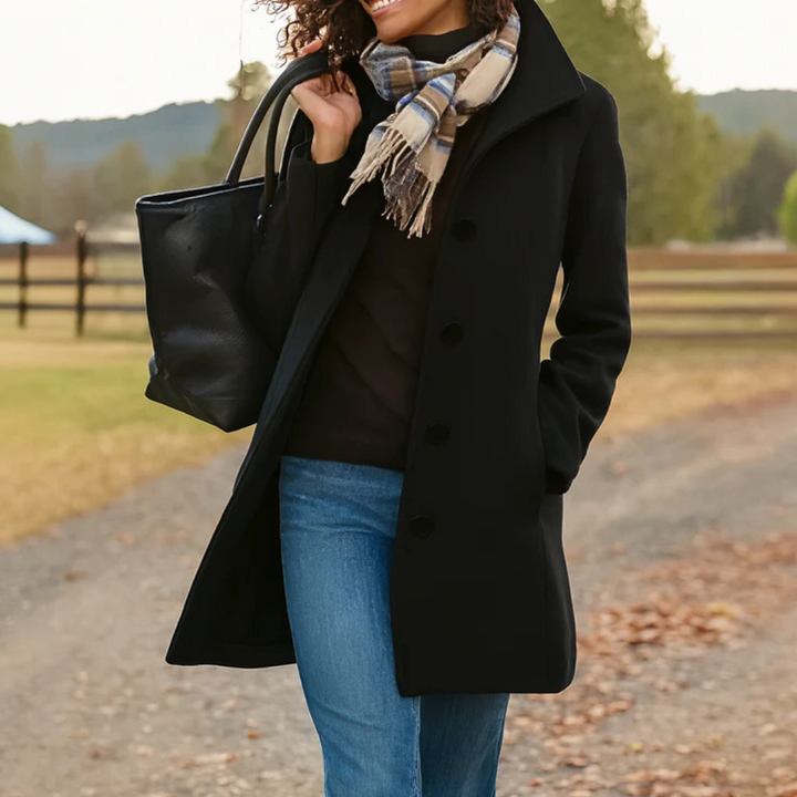 Black long button-front coat with notched lapels and side pockets worn open