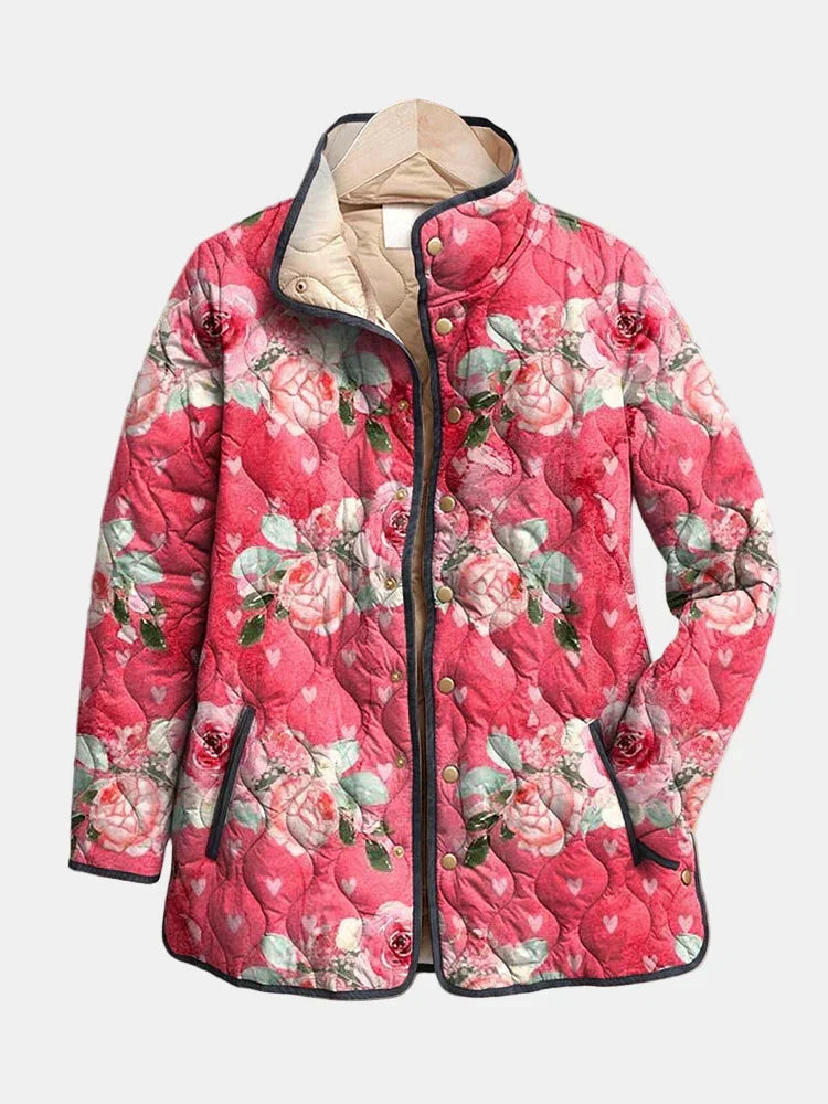 Pink floral quilted jacket with zip front, snap buttons, and stand collar