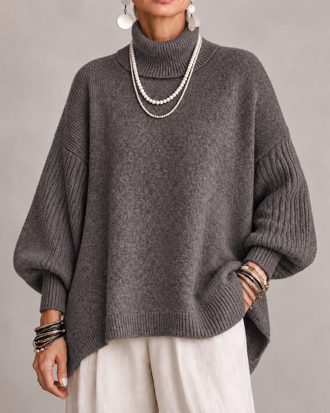 Gray turtleneck knit sweater with ribbed cuffs and relaxed dolman sleeves.