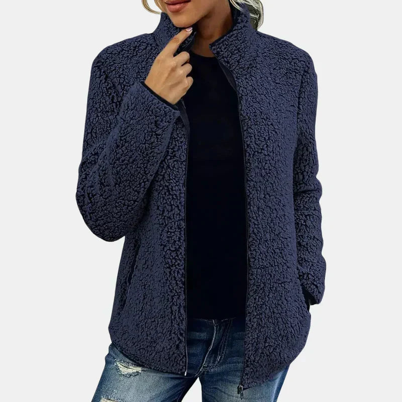 Dark blue teddy jacket with full zipper and stand collar on model