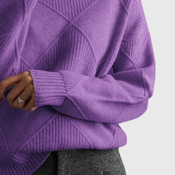 Violet turtleneck jumper close-up of folded cuff and diamond seam knit