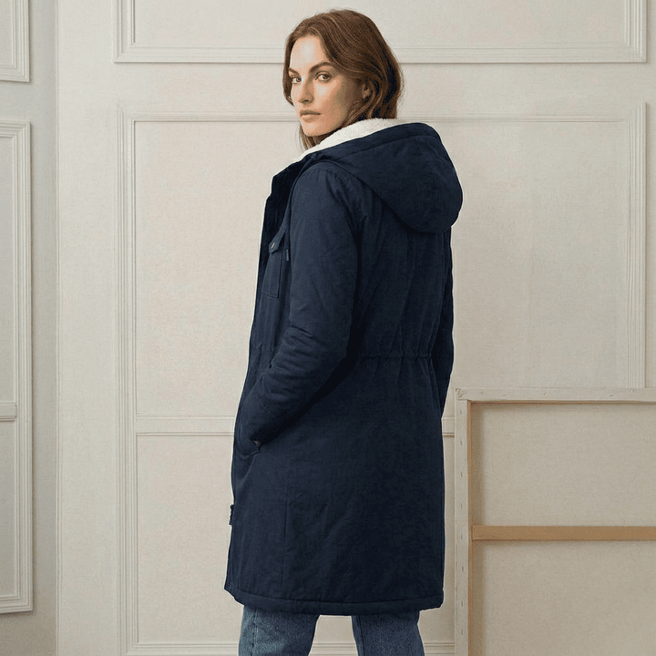 Navy waterproof long parka side view with adjustable hood and sherpa lining
