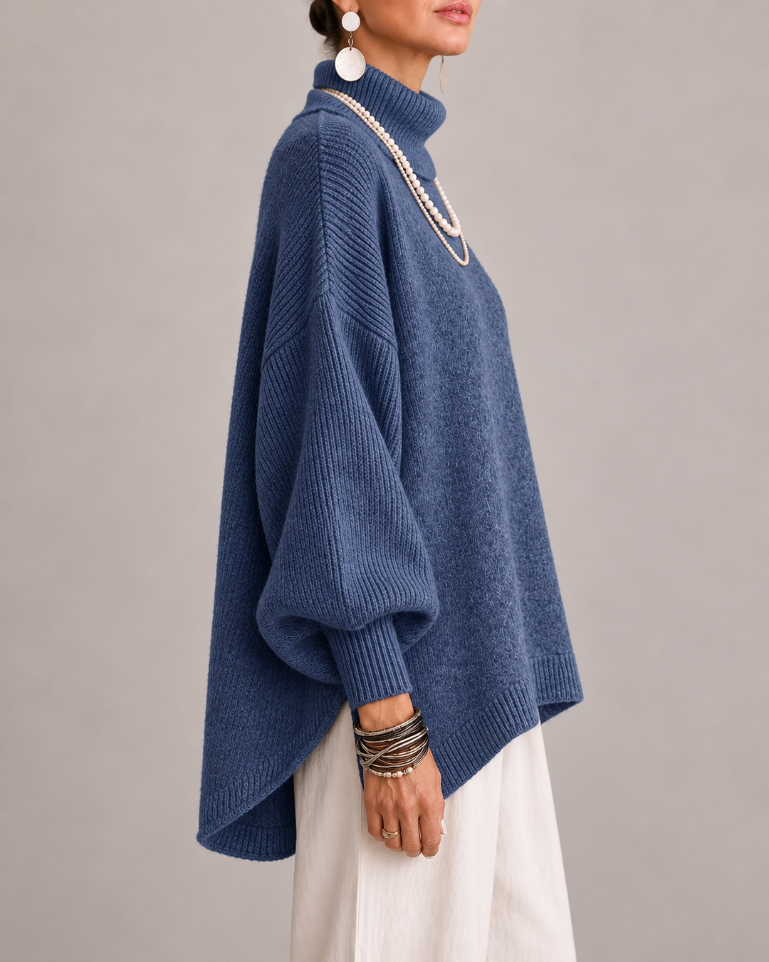 Navy turtleneck knit sweater with ribbed cuffs and loose dolman sleeves.