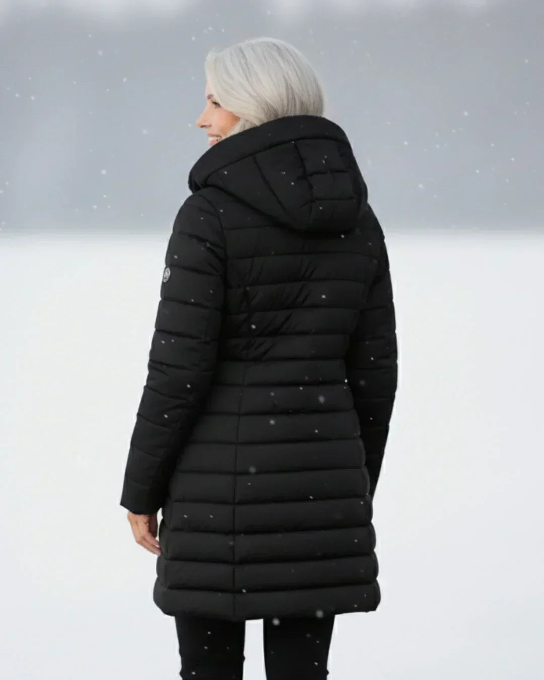 Black long padded winter jacket with hood, stitched panel design (back view)