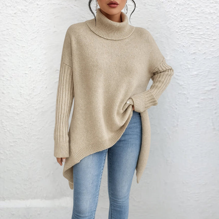 Beige turtleneck sweater with long sleeves and ribbed cuffs, side-slit asymmetrical hem.