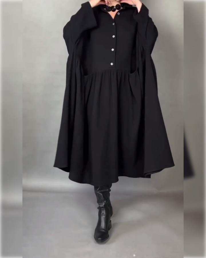 Black button collar A-line dress with long sleeves and gathered skirt panel.