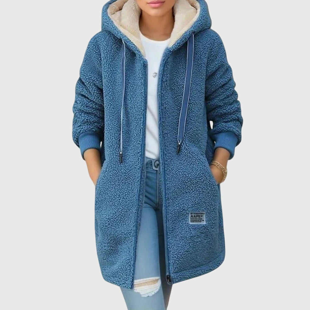 Blue sherpa zip-up hooded coat on model, cream hood lining, drawstring ties, patch logo.