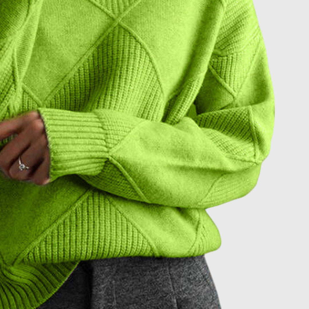 Green turtleneck knit jumper close-up of diamond motif and ribbed cuff detail