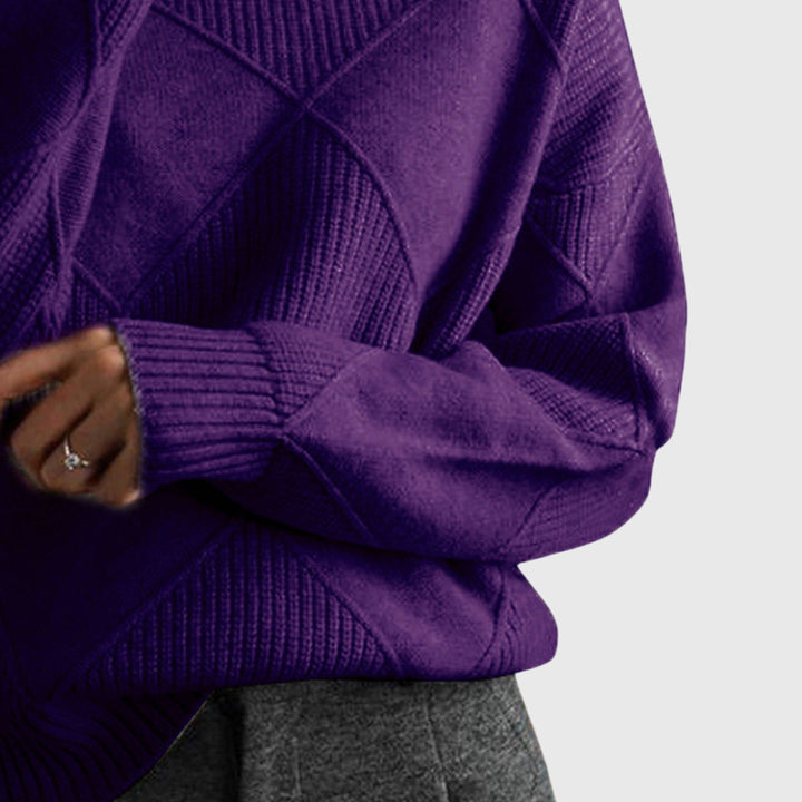 Purple turtleneck jumper sleeve close-up with ribbed cuff and diamond knit