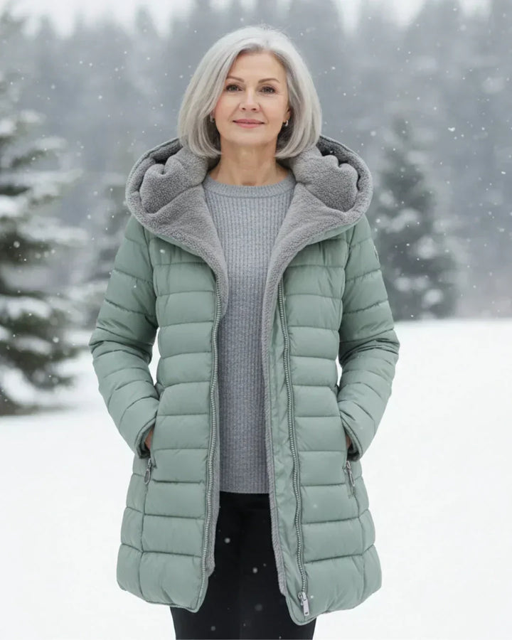 Light green padded winter jacket with gray hood lining, front zipper, side pockets.