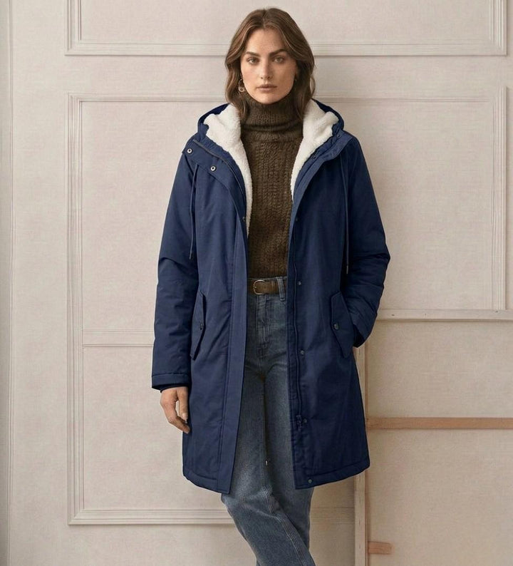 Navy waterproof long parka with sherpa hood lining, zip front, and two chest pockets