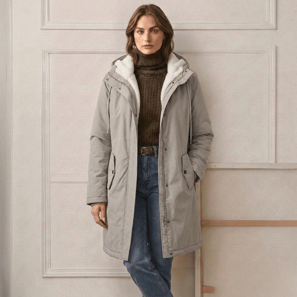 Waterproof long parka with hood, light grey outer shell, sherpa lining, zip front, side pockets.