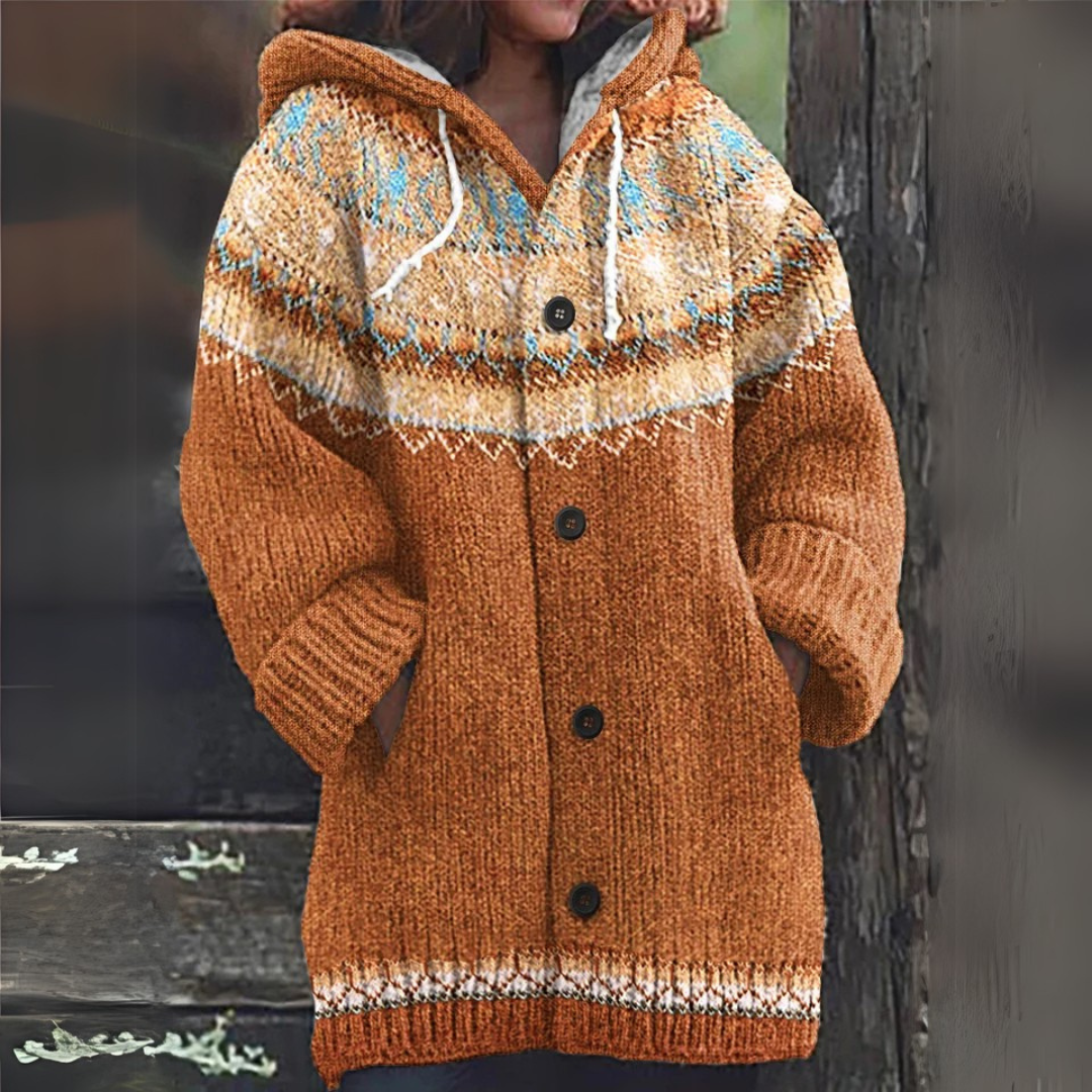 Brown knitted vest with hood, button front, and cream-and-blue patterned yoke hem.