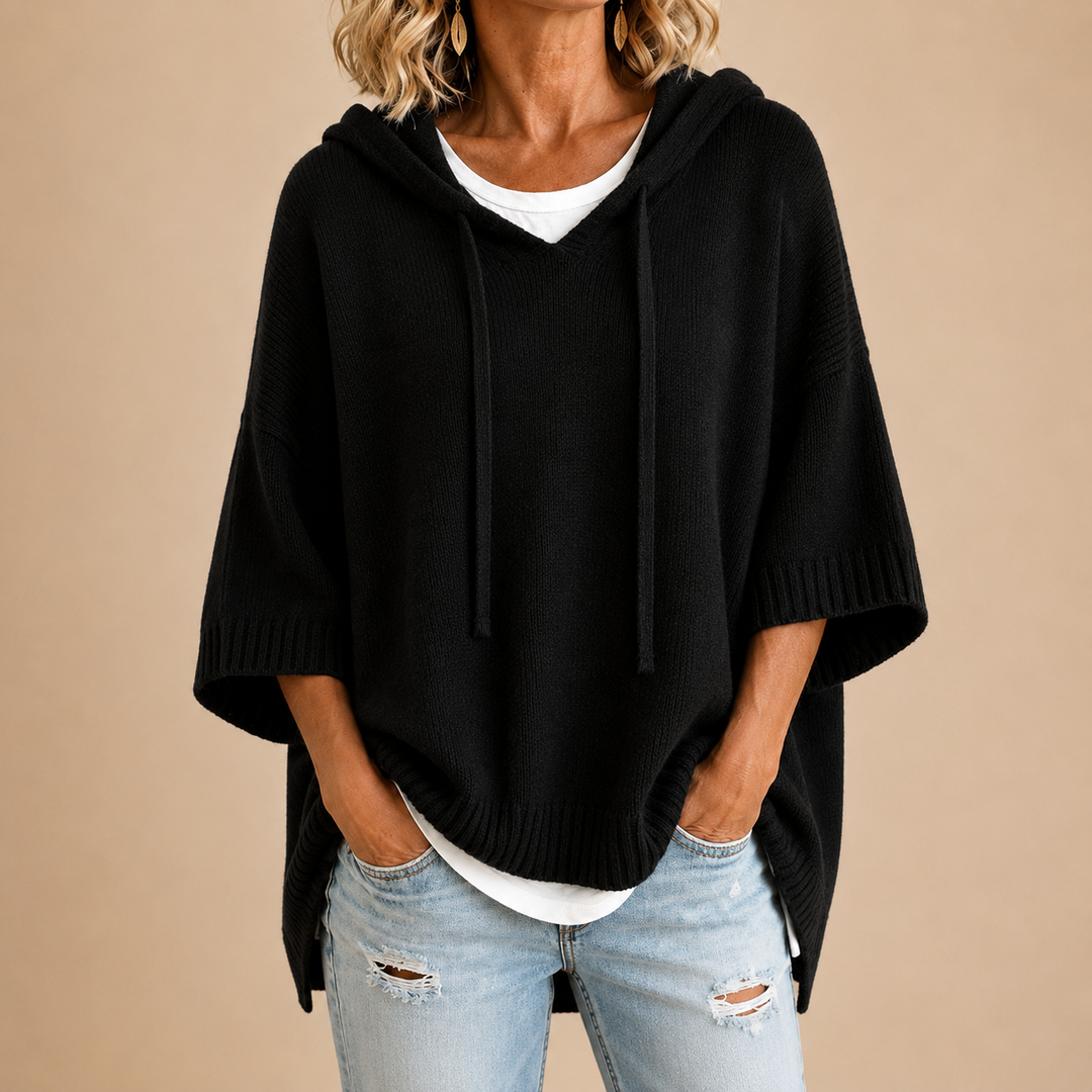Black knit poncho with hood, V-neck front and draped sleeves