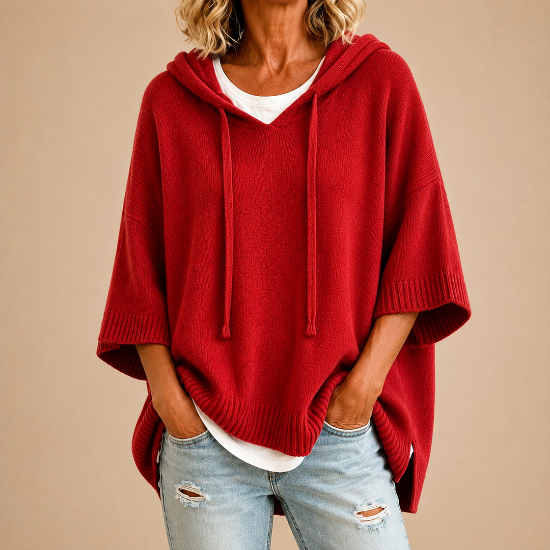 Crimson knit poncho with hood and drawstrings, ribbed hem and half sleeves
