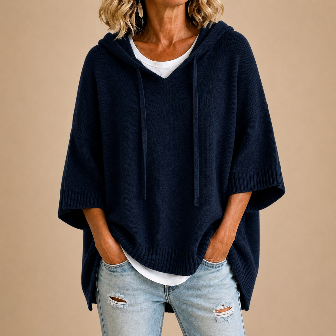 Navy blue knit hooded poncho with drawstring hood and short sleeves