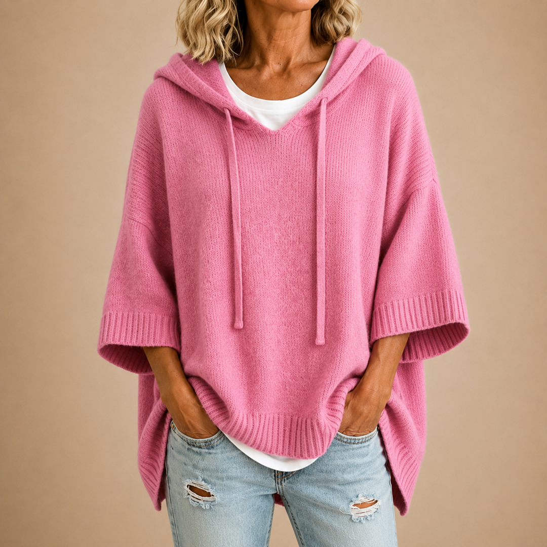 Pink knit hooded poncho sweater with ribbed cuffs and hem