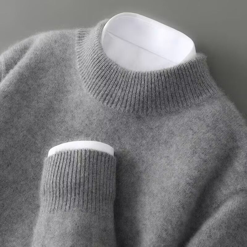 Light grey cashmere turtleneck sweater close-up of ribbed collar and sleeve cuff