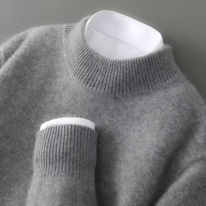 Light grey cashmere turtleneck sweater close-up of ribbed collar and sleeve cuff