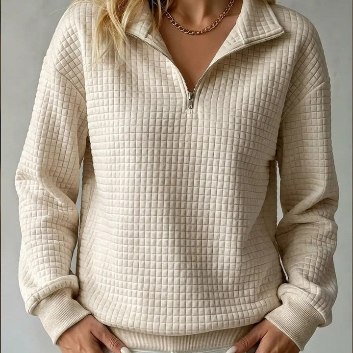 Beige quilted quarter-zip sweater with zip front and ribbed cuffs and hem