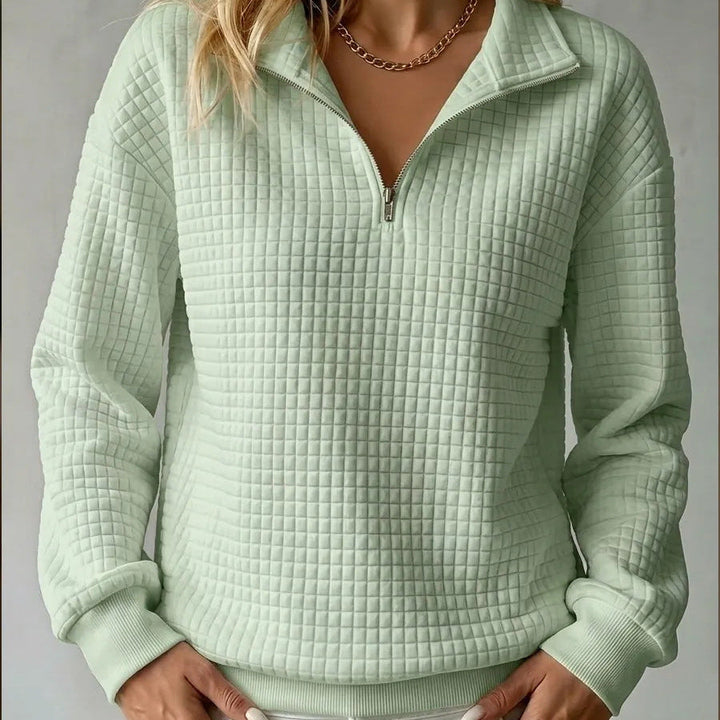 Mint green quilted quarter-zip sweater with zip front and ribbed cuffs and hem