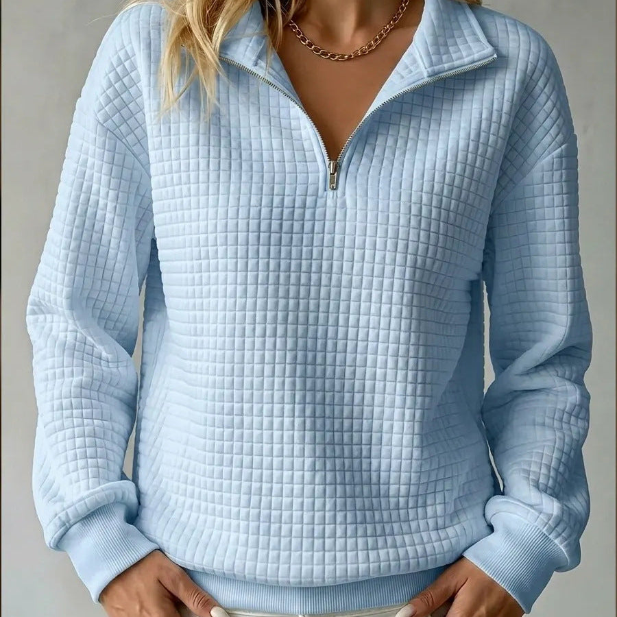 Light blue quilted quarter-zip sweater with stand collar and ribbed cuffs