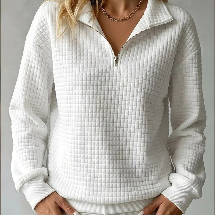 Off-white quilted quarter-zip sweater with zip placket, ribbed cuffs, and hem