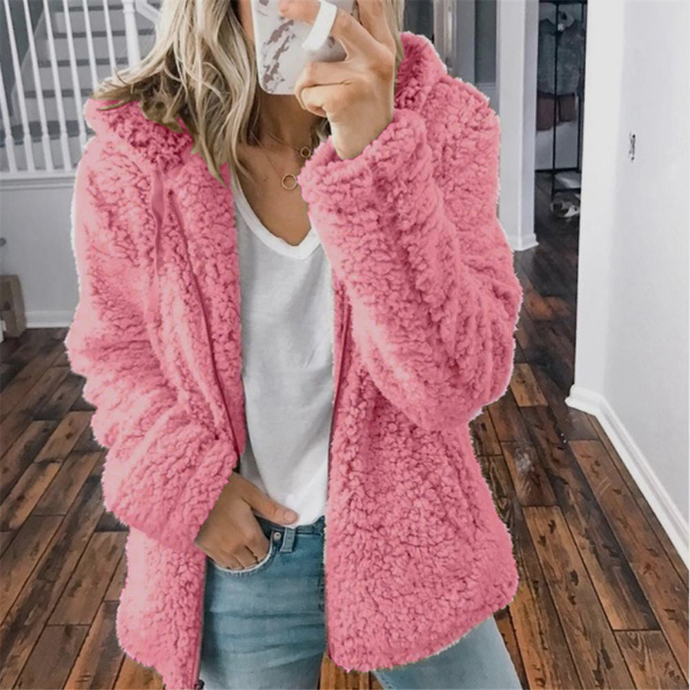 Pink hooded sherpa zip coat worn, with full sleeves and front zipper